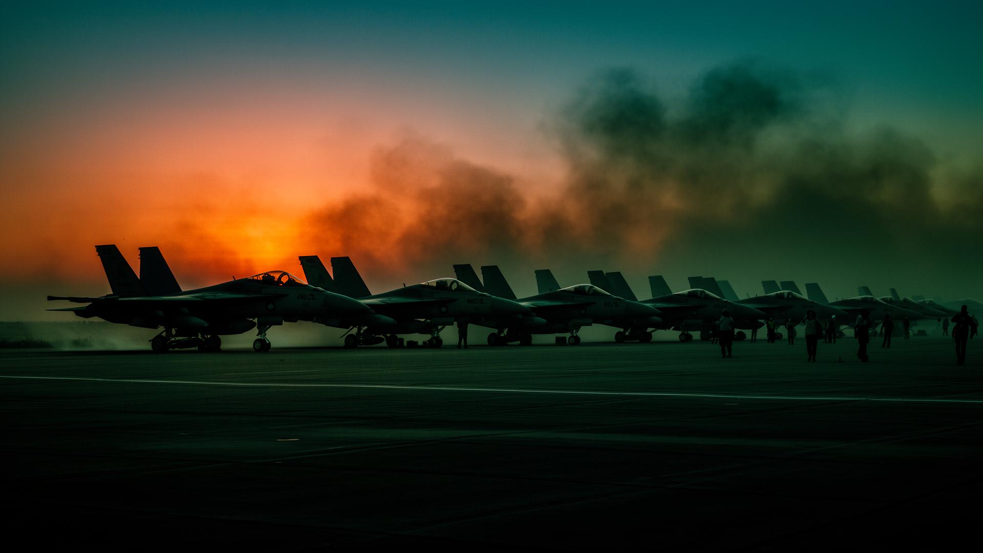 Fighter jets on flightline at dusk